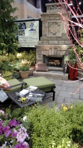 Relax in front of the fireplace in Unique Environmental's garden at the Atlanta Home & Garden Show.